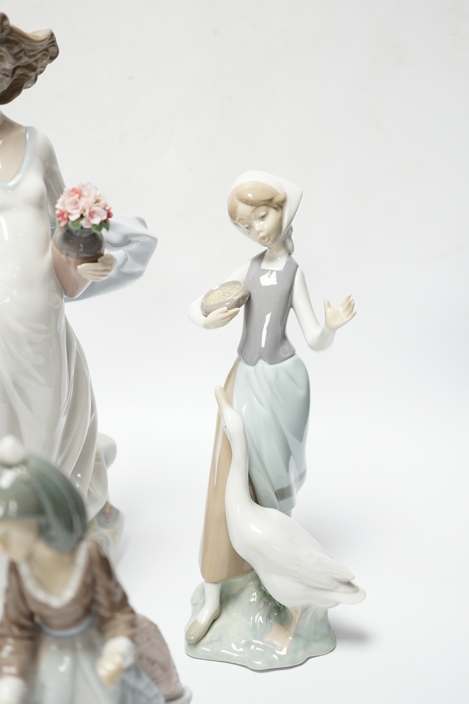 Four Lladro figurines; Reverie Moment, a model of a Ballet Dancer, and three other figurines (only two boxed)